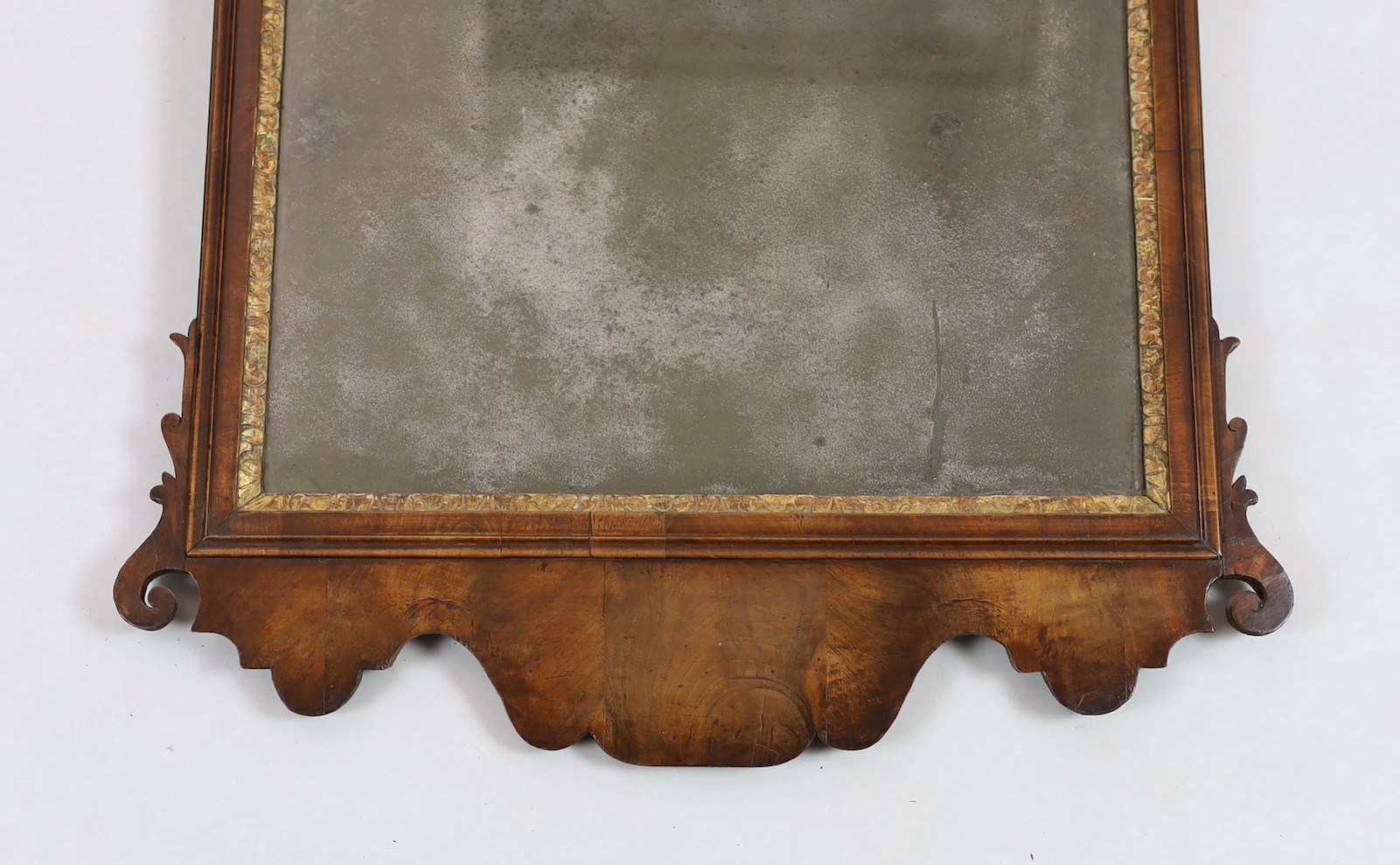 A George II walnut and parcel gilt fret frame wall mirror